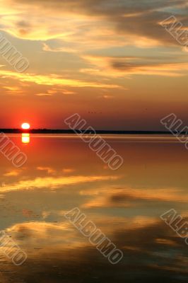 The day begins. The sun both sea and cloud