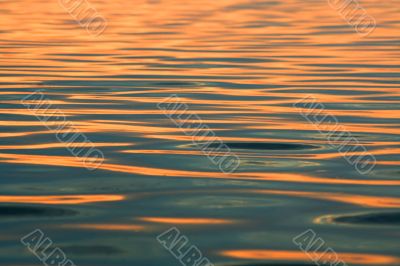Background. Solar sparks on water.