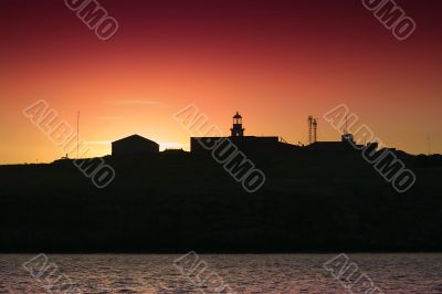 Silhouette of an island and lighthouse Silhouette of an island and lighthouse