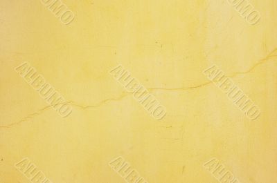 yellow stucco with crack
