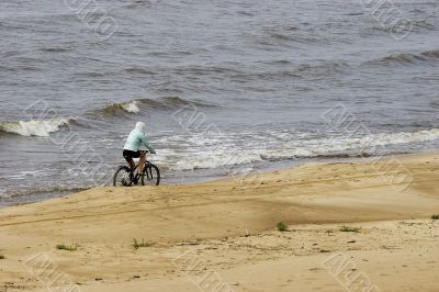 Lonely Cyclist on beach