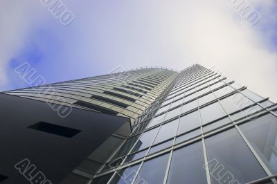 Skyscraper on cloudy sky