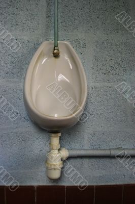 Porcelain urinal on blue wall Porcelain urinal on blue wall