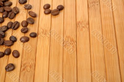 Grains of coffee on a carpet made of a bamboo