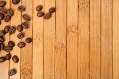 Grains of coffee on a carpet made of a bamboo