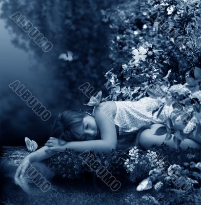 Girl sleeps beside creek