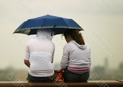 Girlfriends under a umbrella