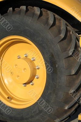 Wheel of a new yellow building tractor