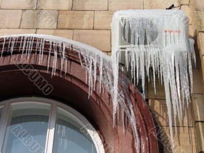 Icicles on the conditioner in frosty day Icicles on the conditioner in frosty day