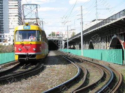 The city tram leaves a tunnel