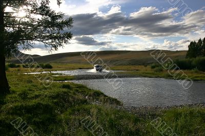 car, river and cloudy sky