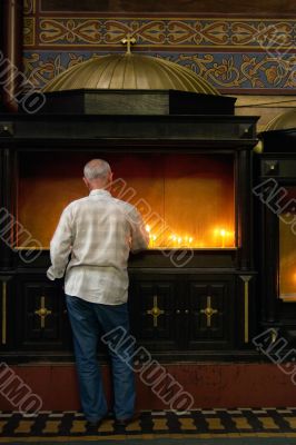 man with candle in churche