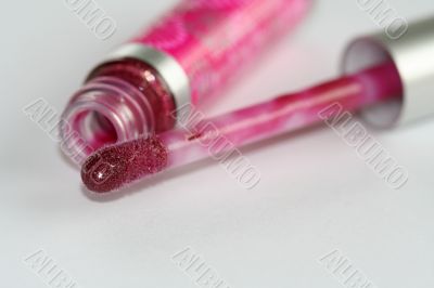 Fuscia lip gloss brush and tube macro