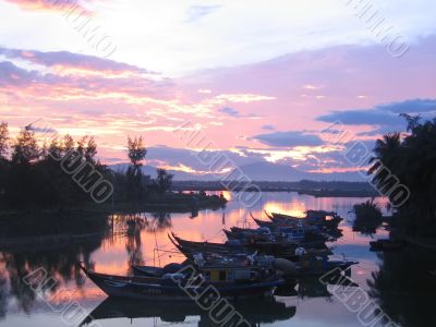 Boats in mooring at sunset