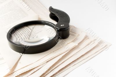 Magnifier and newspaper