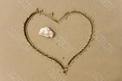 drawing heart on sea sand