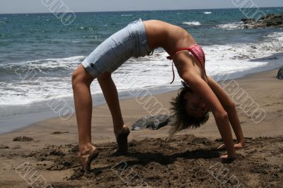 girl, a gymnastics at the seashore