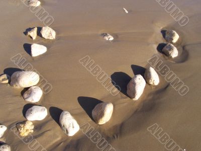 Stone mosaic on marine sand