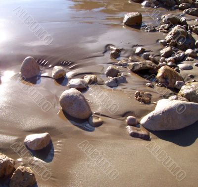 Stone mosaic on marine sand