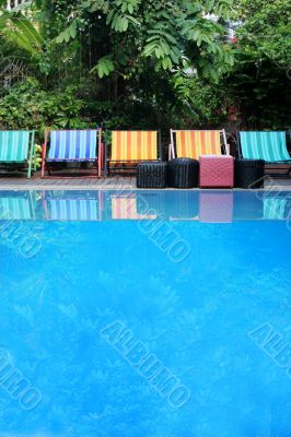 Deck chairs next to a pool