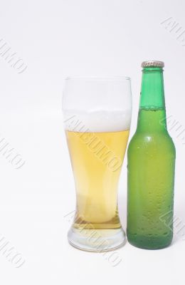 A pilsner glass of beer and a beer in a bottle.