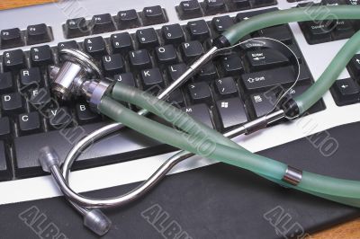 A stethoscope on a computer Keyboard.