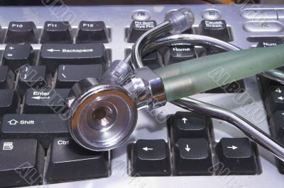 A stethoscope on a computer Keyboard.
