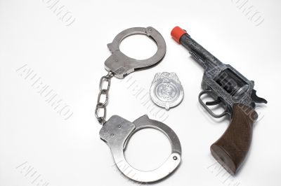 police badge, gun and handcuffs