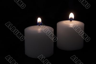 candles burning in a dark room