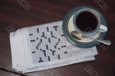 a cup of coffe and the morning crossword puzzle