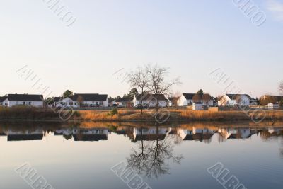 lakeside houses reflected in a lake