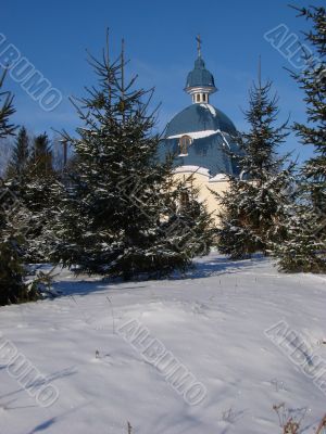 Winter snowy landscape with fur-trees and church