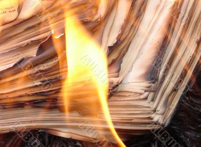 burning stack of paper sheets