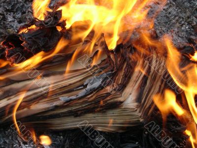 burning stack of paper sheets