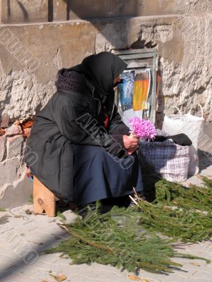 Old woman selling flowers
