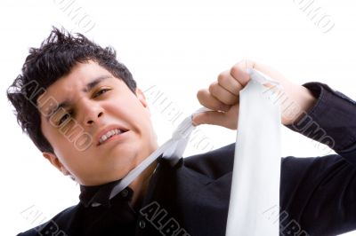 Young man pulling his tie