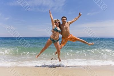 Young men jump on seacoast