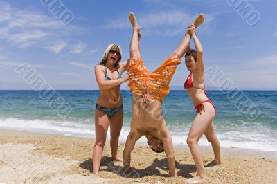 Young men jump on seacoast