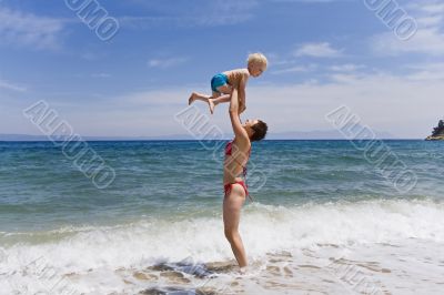 Ma with child on beach