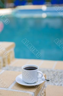cup coffee on background of the pool
