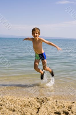 Child jump on seacoast