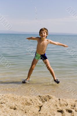 Child jump on seacoast