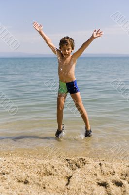Child jump on seacoast