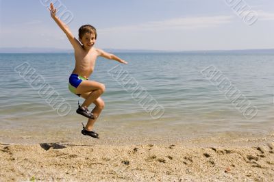 Child jump on seacoast