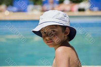 portrait of the boy beside swimming pool
