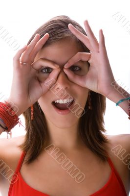 Teen looking with binocular hands