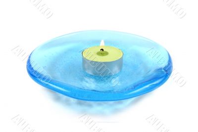 Candle on a blue glass dish