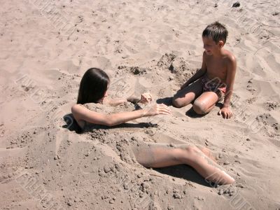 Boy and girl playing in sand