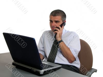 Man speaking to the phone at the office desk