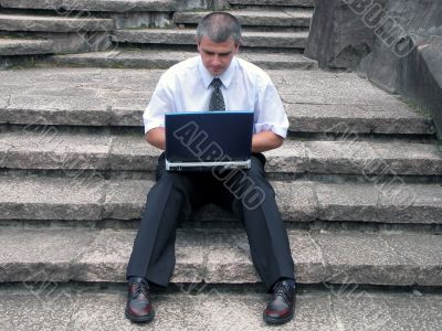 Businessman with laptop outdoor
